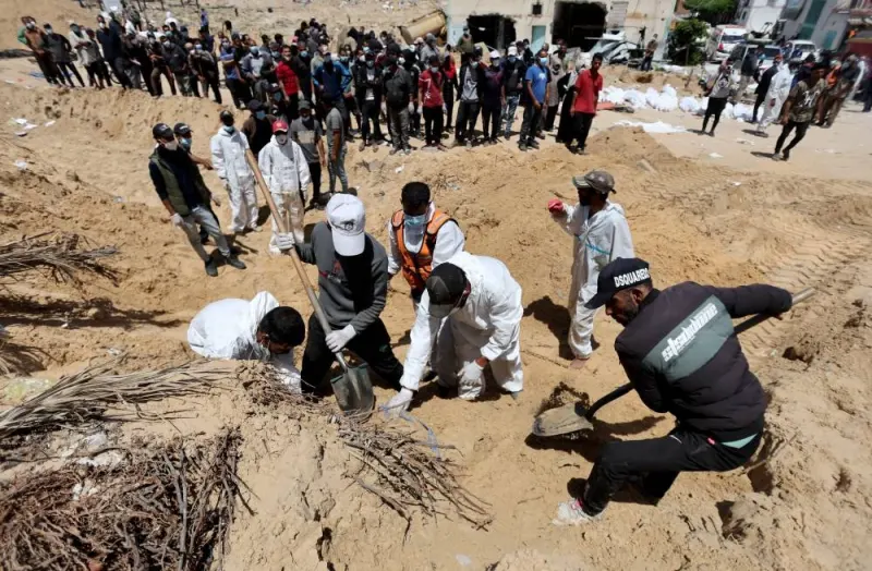 People work to move into a cemetery bodies of Palestinians found buried at Nasser hospital in Khan Younis in the southern Gaza Strip Sunday. Reuters