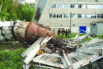 
Police officers are seen near a part of a television tower partially destroyed by a Russian missile strike in Kharkiv. 