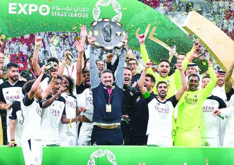 
Al Sadd coach Wesam Rizik celebrates with the QSL Shield.
 