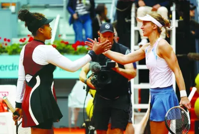 Russia’s Liudmila Samsonova (right) shakes hands with Japan’s Naomi Osaka after winning their round of 64 match at the Madrid Open on Thursday. (Reuters)