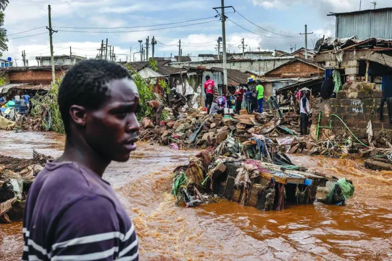 
A man is seen near an area were houses were destroyed by floods following torrential rains at the Mathare informal settlement in Nairobi. 