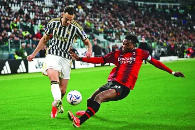 AC Milan’s Rafael Leao (right) tackles Juventus’ Federico Gatti during the Serie A match in Turin, Italy, on Saturday. (AFP)