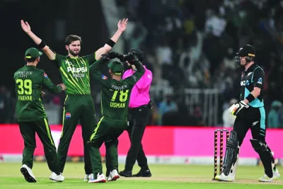 Pakistan’s Shaheen Shah Afridi (second from left) celebrates with teammates after taking the wicket of New Zealand’s Jimmy Neesham during the fifth and last T20I in Lahore on Saturday. (AFP)