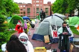 
Activists and students protest near an encampment at University Yard at George Washington University in Washington, DC. 