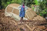
Right: A girl stands next to a car buried in mud in an area heavily affected by torrential rains and flash floods in the village of Kamuchiri, near Mai Mahiu, in Kenya. 