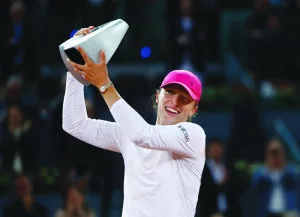 Poland’s Iga Swiatek celebrates with the trophy after winning the Madrid Open final against Belarus’ Aryna Sabalenka on Saturday. (Reuters)