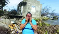 
A resident of El Bosque cries in front of what is left of her house as rising sea levels are destroying homes built on the shoreline and forcing villagers to relocate, in El Bosque, Mexico. (Reuters) 