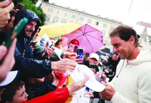 
Rafael Nadal signs autographs for fans at the Italian Open. (Reuters)  