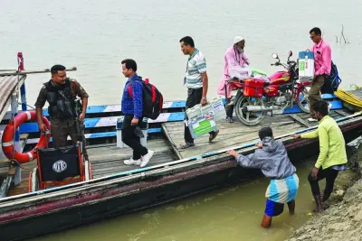 
Election officials carry Electronic Voting Machines to a polling station on a boat ahead of the third phase of voting of India’s general election, at the banks of river Brahmaputra in Kamrup, Assam, on Monday. (AFP) 