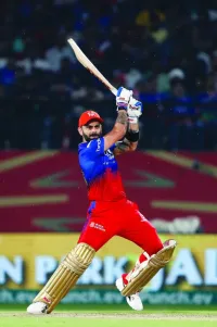 Royal Challengers Bengaluru’s Virat Kohli watches the ball after playing a shot during the Indian Premier League match against Punjab Kings at the Himachal Pradesh Cricket Association Stadium in Dharamsala on Thursday. (AFP)