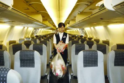 A cabin attendant carries bags of trash as she conducts her cleaning duties in the cabin of a Japan Airlines airplane at Haneda Airport in Tokyo (file). A growing challenge for airlines is the sustainable management of millions of tonnes of waste generated within the cabin. A cabin attendant carries bags of trash as she conducts her cleaning duties in the cabin of a Japan Airlines airplane at Haneda Airport in Tokyo (file). A growing challenge for airlines is the sustainable management of millions of tonnes of waste generated within the cabin.