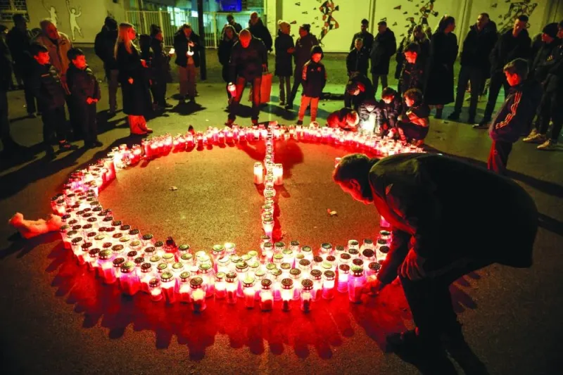 People lay candles following a knife attack in a primary school in Zagreb. (Reuters)  
People lay candles following a knife attack in a primary school in Zagreb. (Reuters)