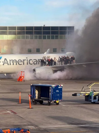 Passengers standing on the wing of an American Airlines plane as they are evacuated after it caught fire while at a gate at Denver International Airport in Denver, Colorado, on Friday. AFP/ HANDOUT / Branden WILLIAMS Passengers standing on the wing of an American Airlines plane as they are evacuated after it caught fire while at a gate at Denver International Airport in Denver, Colorado, on Friday. AFP/ HANDOUT / Branden WILLIAMS