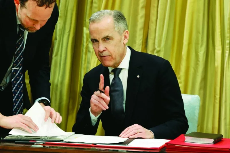 Leader of the Liberal Party of Canada Mark Carney signs documents during his swearing-in ceremony as Canada's next Prime Minister at an event in Ottawa, Ontario, Canada, March 14, 2025. REUTERS/Blair Gable TPX IMAGES OF THE DAY Leader of the Liberal Party of Canada Mark Carney signs documents during his swearing-in ceremony as Canada's next Prime Minister at an event in Ottawa, Ontario, Canada, March 14, 2025. REUTERS/Blair Gable TPX IMAGES OF THE DAY
