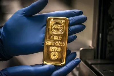 A worker displays a one-kilogram gold bullion bar at the ABC Refinery in Sydney. (AFP) A worker displays a one-kilogram gold bullion bar at the ABC Refinery in Sydney. (AFP)