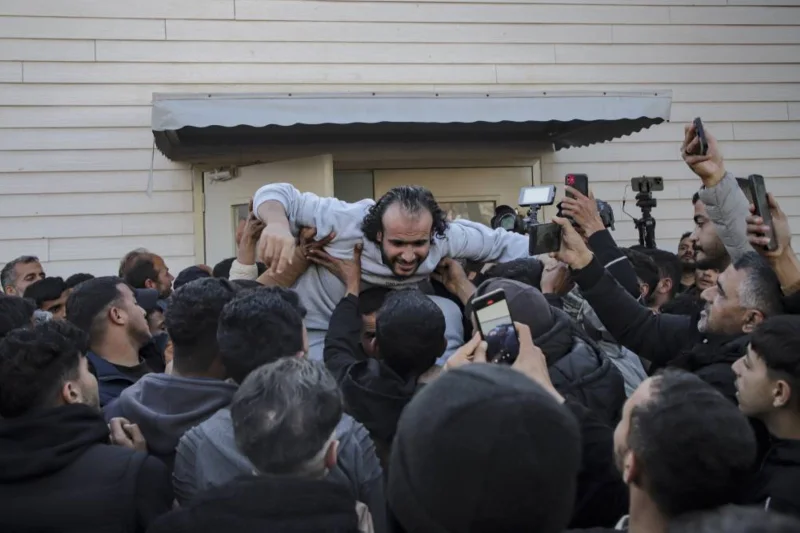 Crowds cheer, families hug as Palestinian prisoners released 3 Crowds cheer, families hug as Palestinian prisoners released