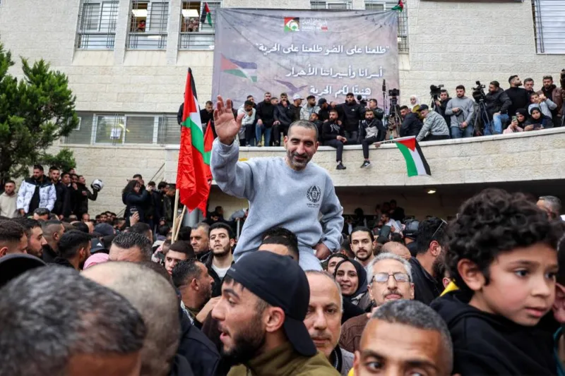 Crowds cheer, families hug as Palestinian prisoners released 4 Crowds cheer, families hug as Palestinian prisoners released