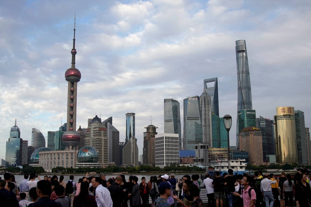 People visit the Bund in front of Shanghai's financial district in September 2017.