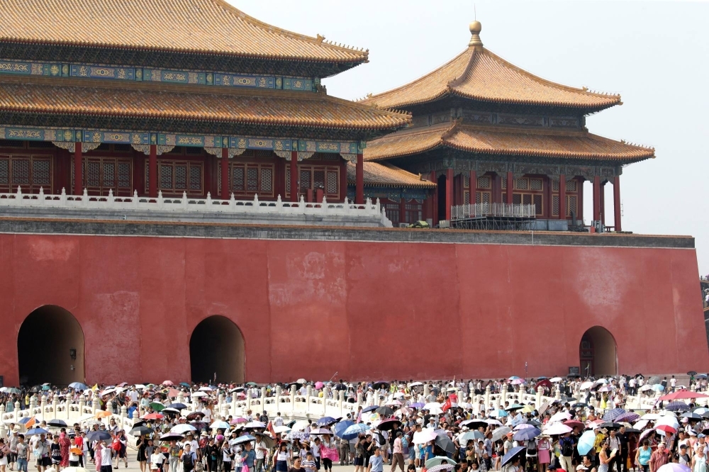 Tourists visit the Forbidden City in central Beijing in July 2018.