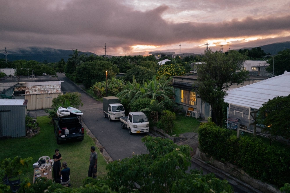 Residents of Taketomi, a town on Iriomote Island, enjoy a barbecue together as the sun sets.