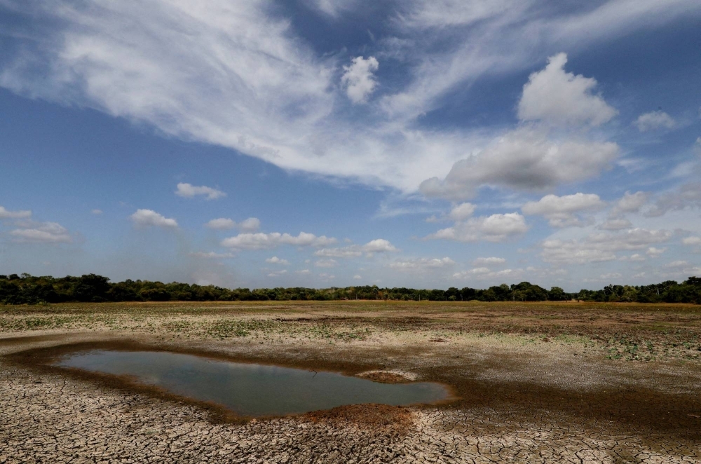 A dried-up lake, used for collecting water for farming, amid drought in Anamaduwa, Sri Lanka