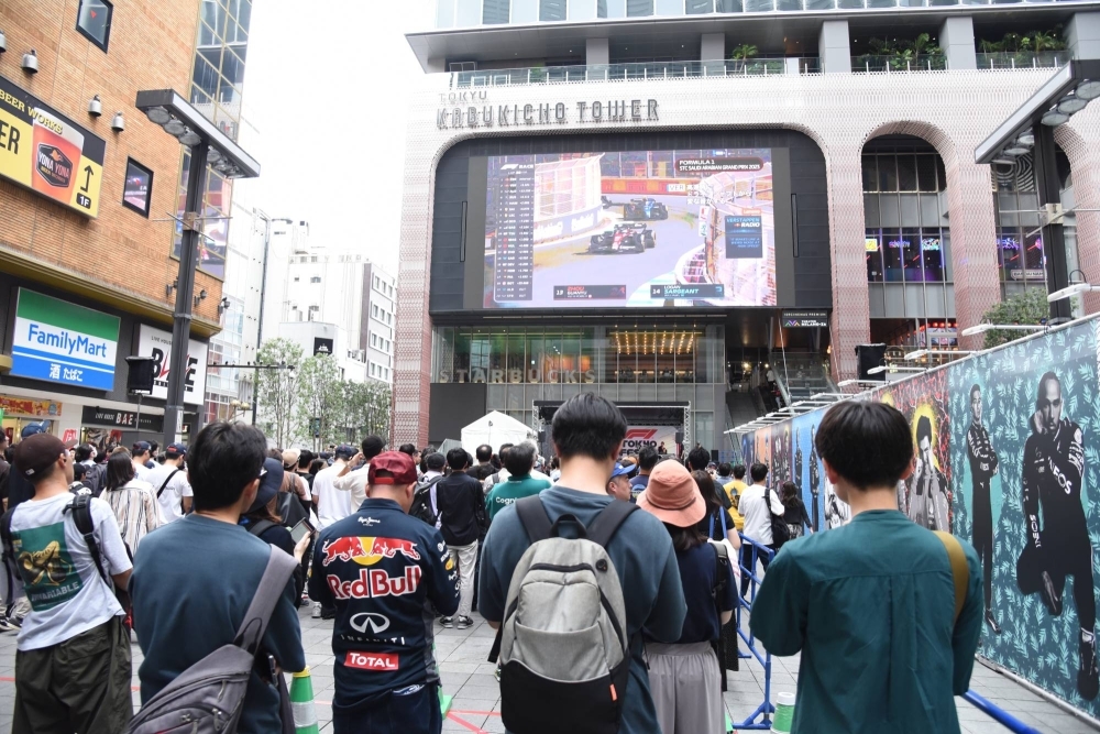 Fans await the start of the F1 Tokyo Festival event in Tokyo's Kabukicho nightlife district on Wednesday.