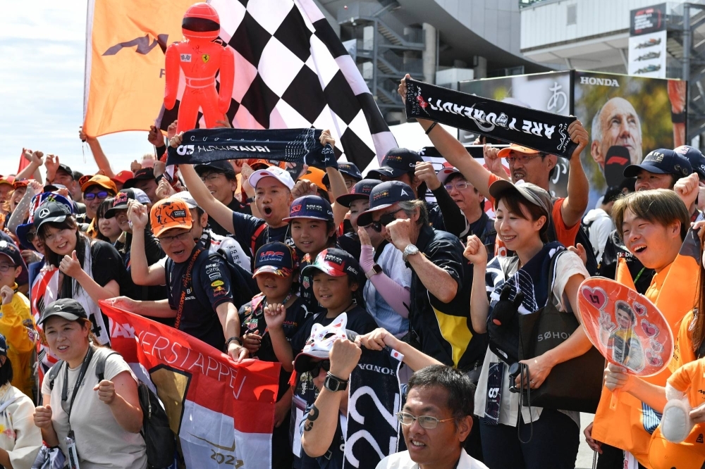 Formula One fans pose for photos ahead of the Japanese Grand Prix on Sunday at Suzuka Circuit in Mie Prefecture.