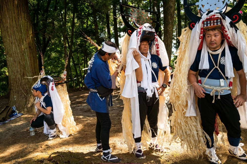 Shishi-odori dancers take a rest between performances at Sugawara Shrine in Tono, Iwate Prefecture.