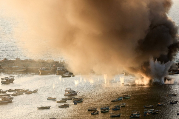 Smoke fills the sky after a strike on the port of Gaza City on Tuesday.