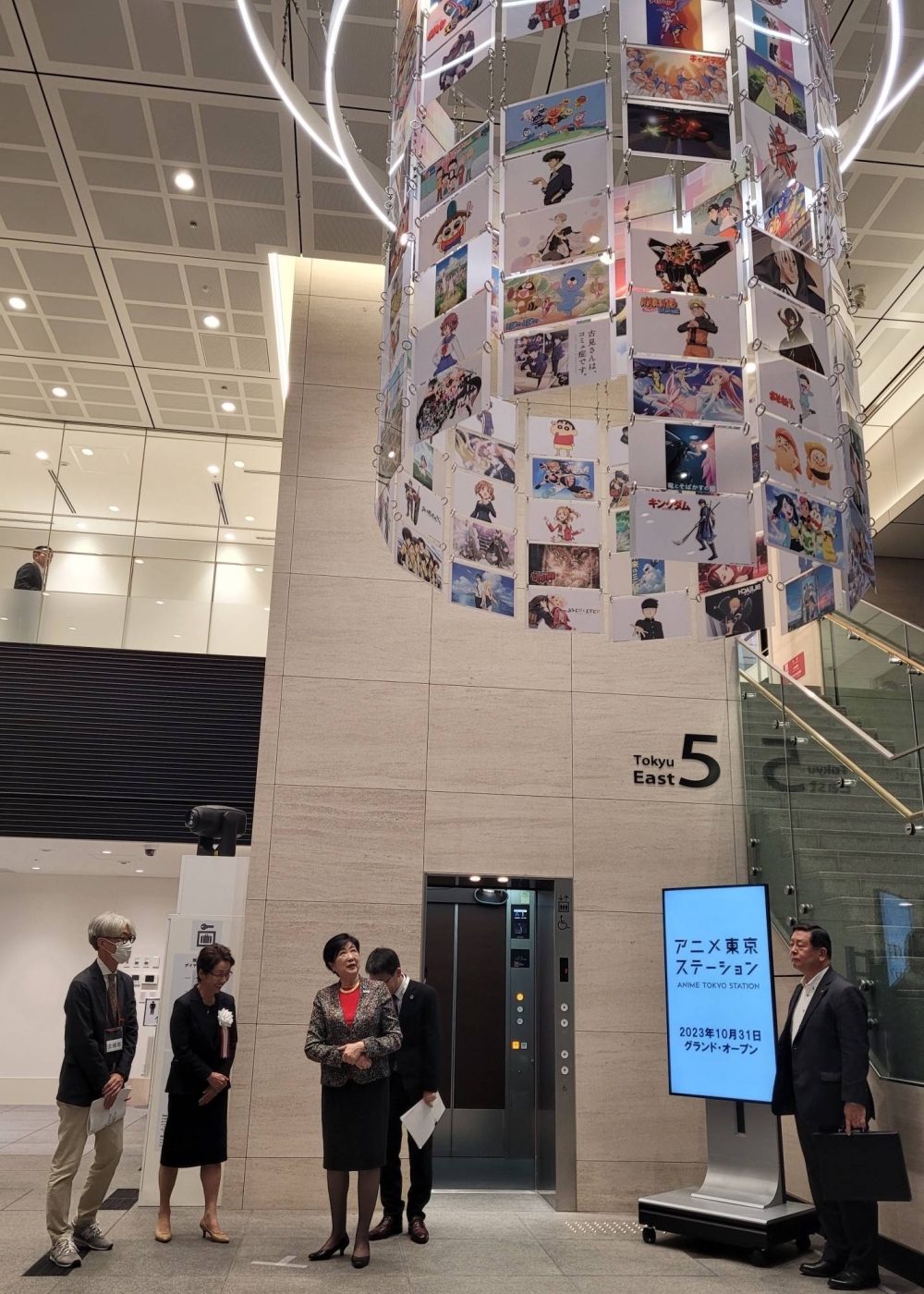 Tokyo Gov. Yuriko Koike (center) gets a tour of the new Anime Tokyo Station on Monday.