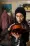 Palestinian musician Jawaher Al-Aqraa holds a violin out of its case as she stands in the kitchen of her home.