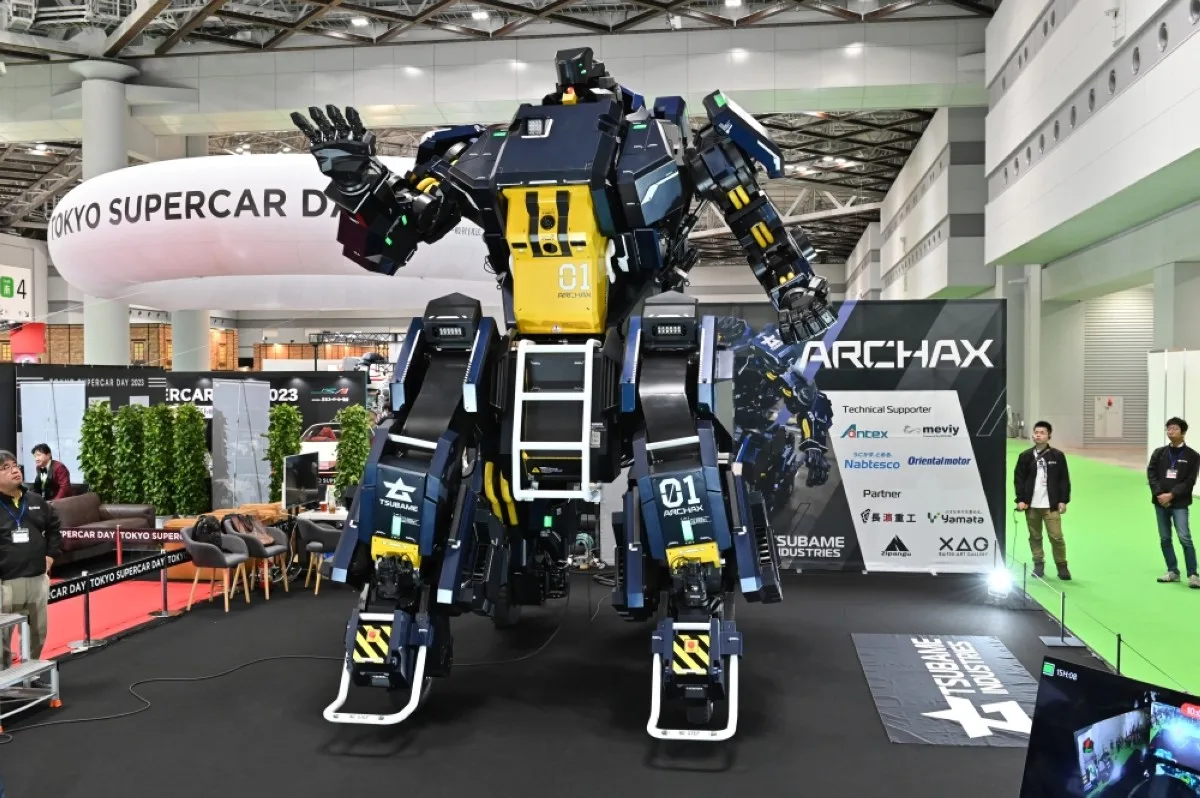 TOKYO: Japanese robotics startup Tsubame Industries exhibit the ARCHAX robot, weighing 3.5 tonnes and measuring 4.5 meters in height, during the press day of the Japan Mobility Show in Tokyo. – AFP