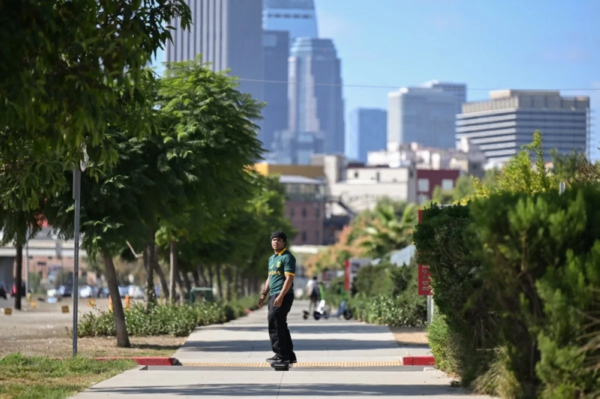 Youth climate activist Sim Bilal, 21, rides his Onewheel, in Los Angeles, California. -- AFP