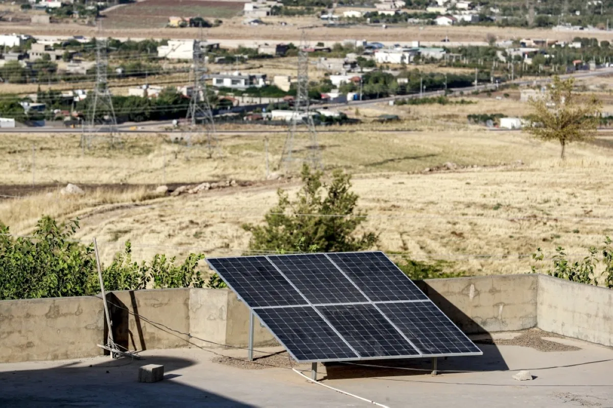 Solar panels installed atop the roof of a house in the Hazer Merd village near Sulaymaniyah in northern Iraq's autonomous Kurdish region are pictured on September 19, 2023. - Despite its vast oil wealth, Iraq struggles to provide enough electricity to its 43 million people after decades of conflict and sanctions, as well as rampant corruption and crumbling infrastructure. And even though it is blessed with more sunshine than most other countries, it has proved difficult to wean Iraq's economy off fossil fuels - one of the themes of the upcoming climate COP28 talks in Dubai. (Photo by Ahmad AL-RUBAYE / AFP)