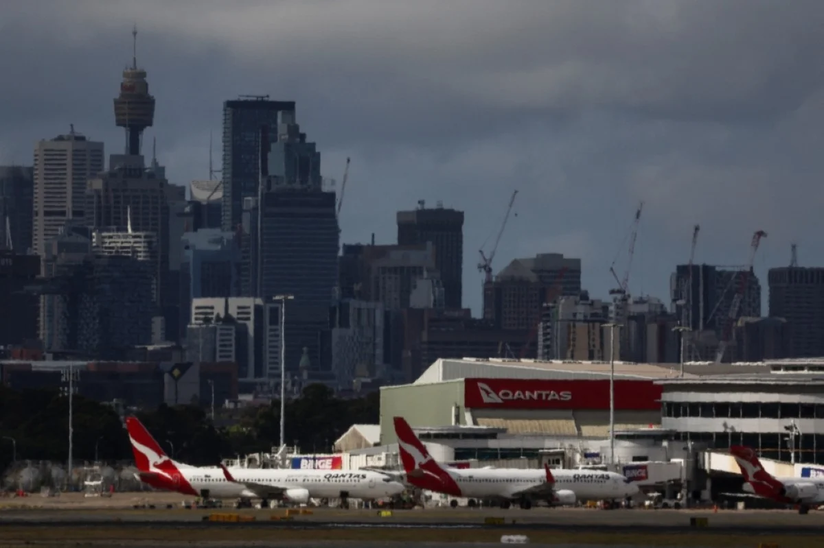 SYDNEY: The Sydney central business district (CBD) can be seen behind Qantas Airways planes sitting at the domestic terminal of Sydney's Kingsford Smith international airport on November 3, 2023. -- AFP