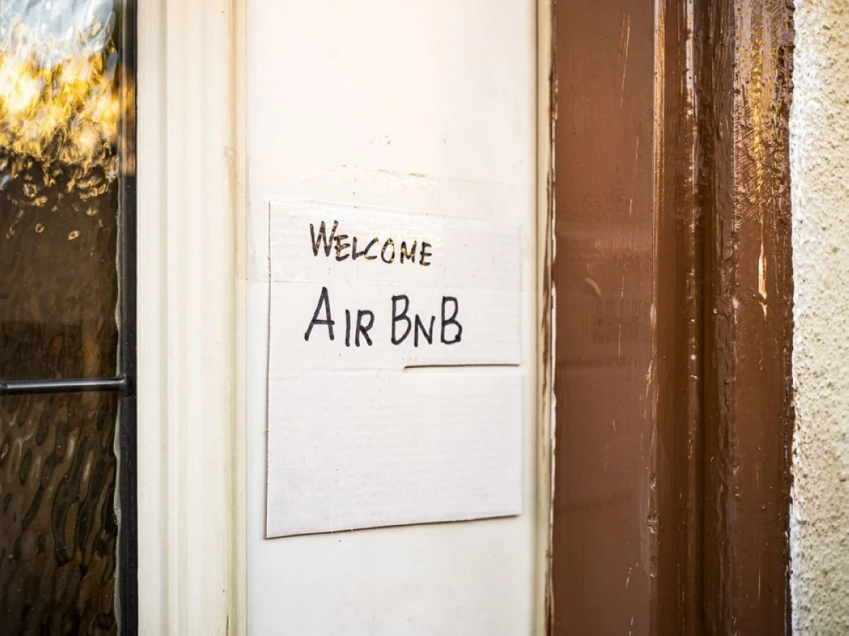 A hand-drawn sign hangs on the door of a home available for short-term rentals through Airbnb in Los Angeles, California.