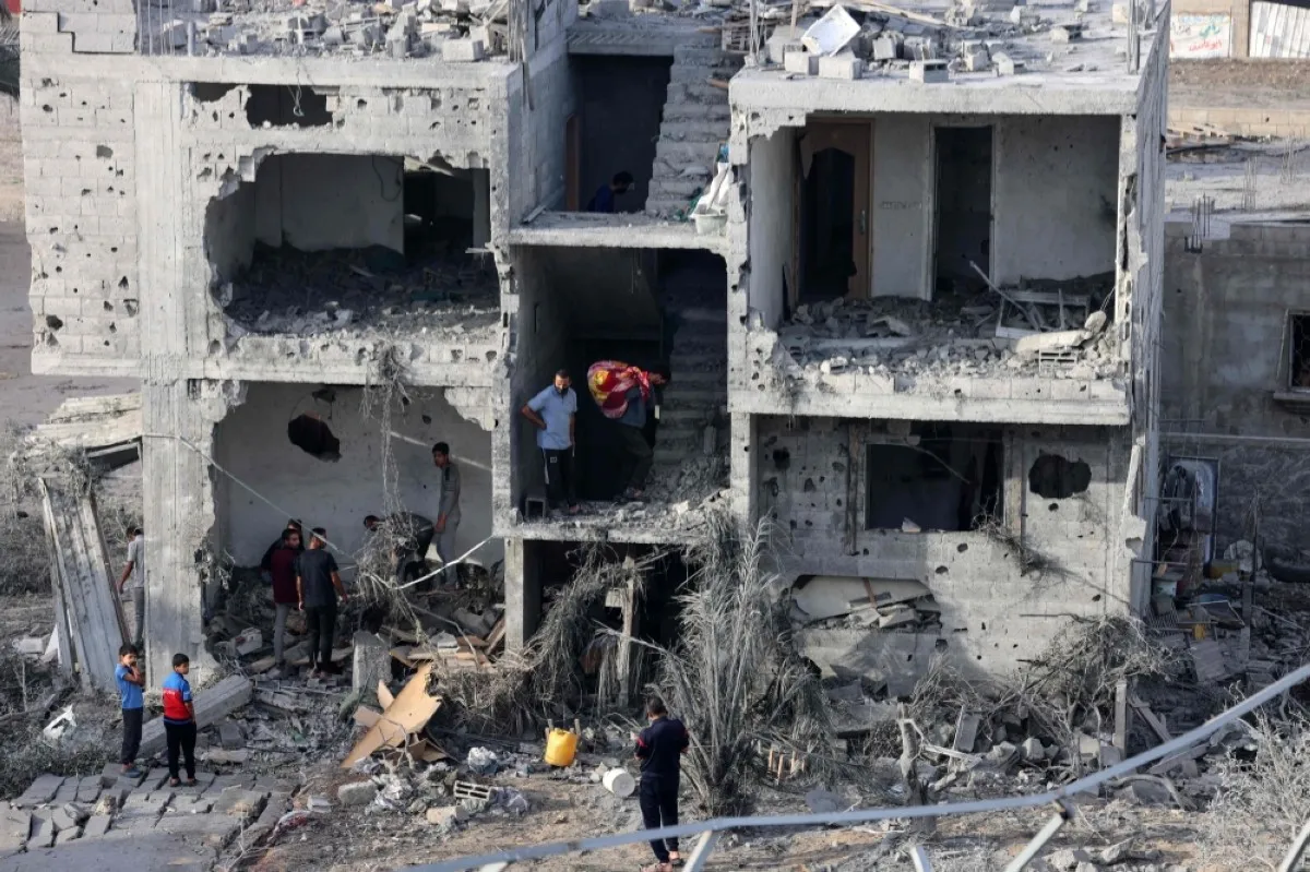 GAZA: People salvage some belongings from a damaged building following Zionist bombing on Rafah in the southern Gaza Strip on Nov 11, 2023. – AFP