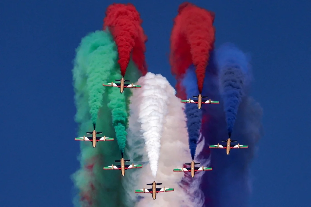 DUBAI: Aermacchi MB-339 trainer aircraft of the Fursan Al-Emarat (UAE Knights) aerobatics team release smoke as they fly over during the 2023 Dubai Airshow at Dubai World Central on November 14, 2023. -- AFP
