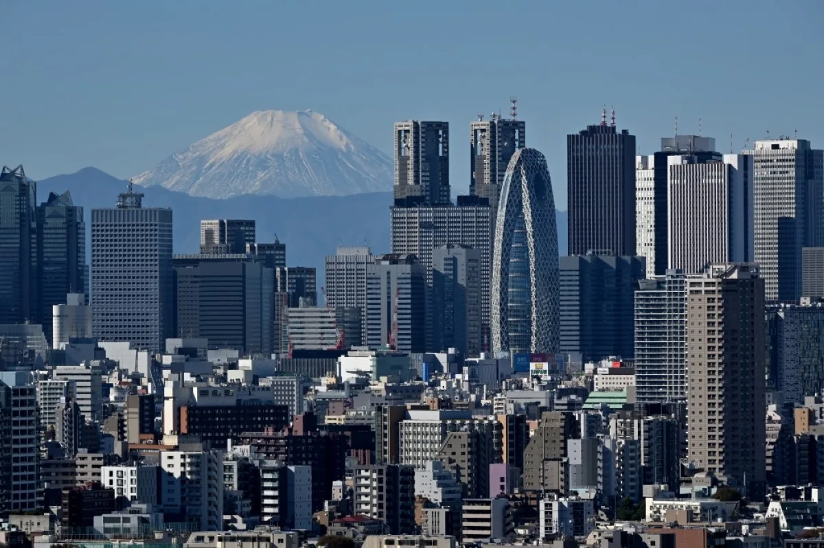 TOKYO: This picture taken on November 14, 2023 shows Japan's highest mountain, Mt. Fuji in the background between skyscrapers in Tokyo's Shinjuku area. – AFP