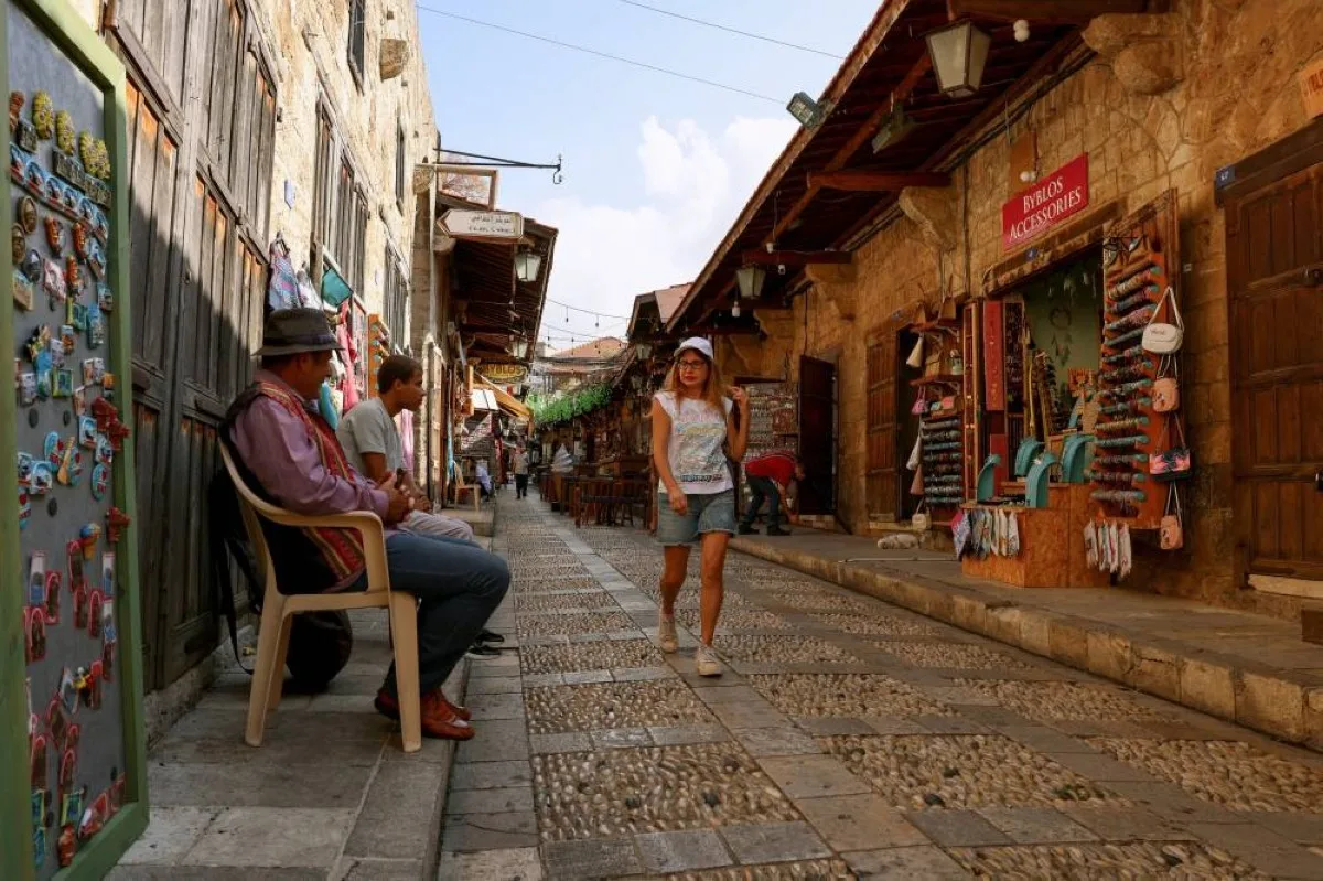 BYBLOS: People walk past souvenir shops at the almost deserted old market in the historical port city of Byblos. Four years into an economic meltdown, Lebanon’s restaurants, cafes, hotels and shops now face yet another challenge. – AFP
