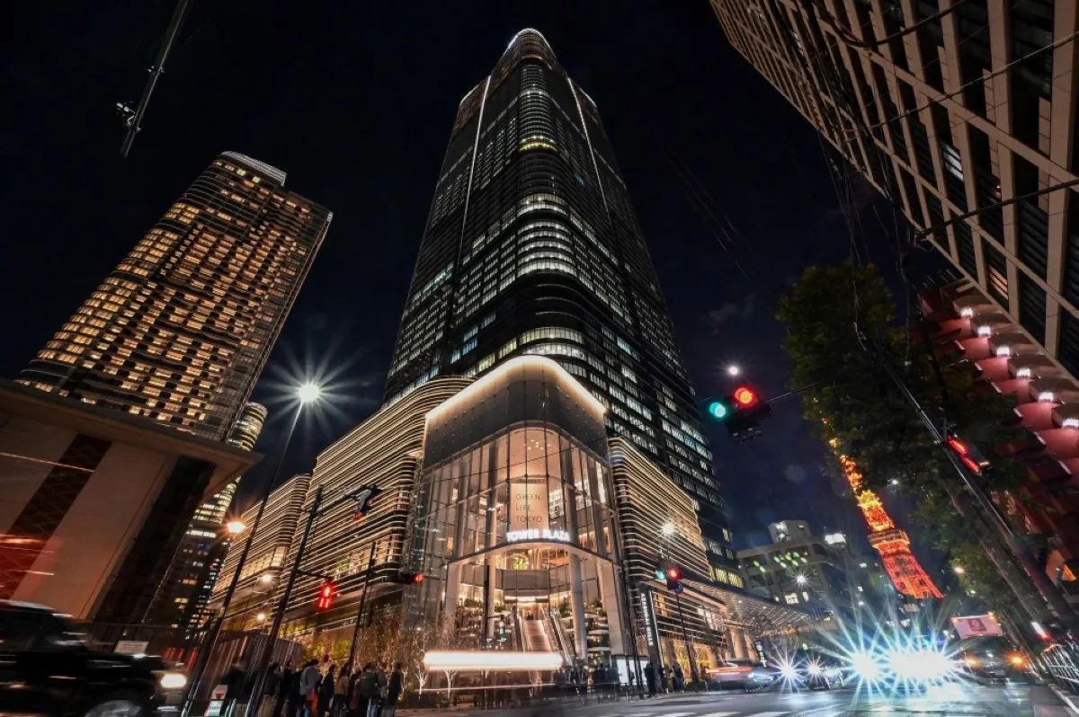 TOKYO: This general view shows a night view of Tokyo's newest skyscraper, the Azabudai Hills Mori JP Tower complex, after its official opening earlier in the day as Tokyo Tower (back R) looms nearby in central Tokyo on November 24, 2023. -- AFP