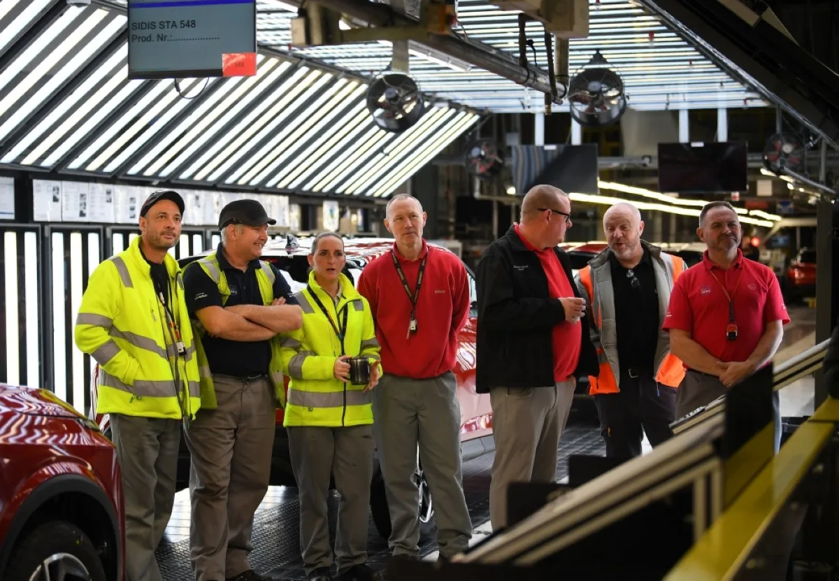 SUNDERLAND, UK: Workers listen as the Nissan President and CEO delivers a speech at the Nissan production plant in Sunderland, north east England on November 24, 2023, where the Japanese vehicle manufacturer announced it will produce electric models of two best-selling cars. -- AFP