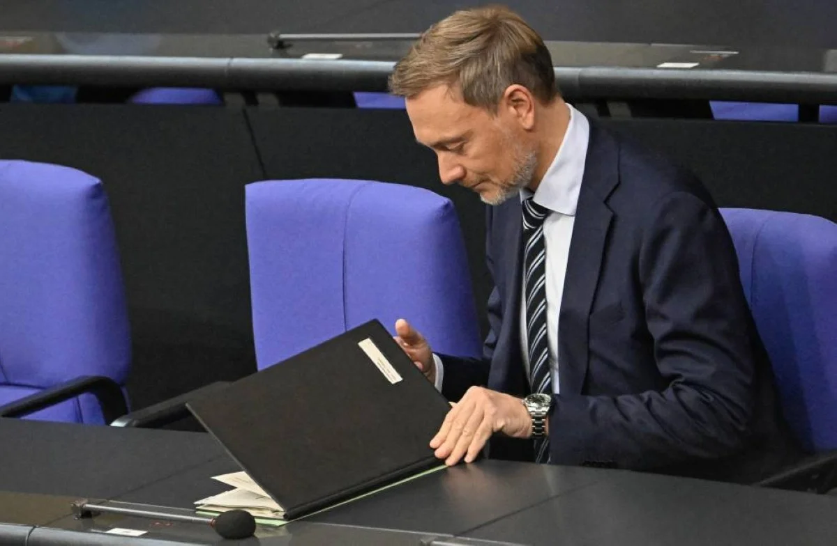 BERLIN: German Finance Minister Christian Lindner opens a folder with documents prior to a debate about a budget crisis at the Bundestag (lower house of parliament), on November 28, 2023 in Berlin.—AFP