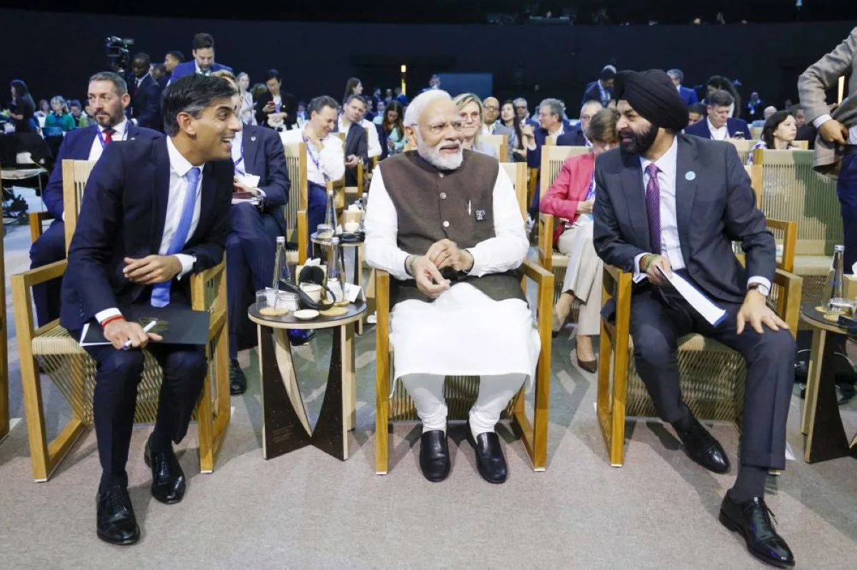 India Prime Minister Narendra Modi (C) and British Prime Minister Rishi Sunak (L) listen to World Bank President Ajay Banga during the Transforming Climate Finance session at the United Nations climate summit in Dubai on December 1, 2023. World leaders take centre stage at UN climate talks in Dubai on December 1, under pressure to step up efforts to limit global warming as the Israel-Hamas conflict casts a shadow over the summit. (Photo by Ludovic MARIN / AFP)