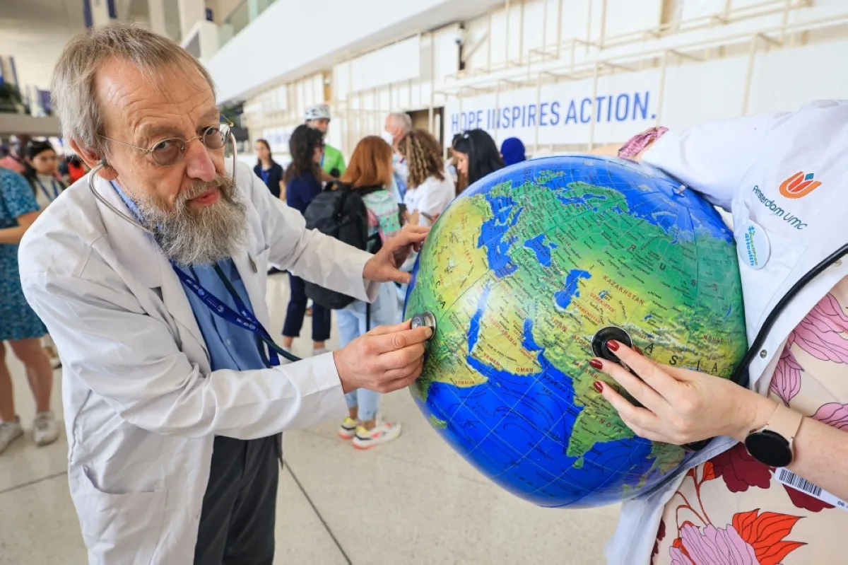 DUBAI: Environmental activists stage a protest with a earth globe during a demonstration at the venue of the COP28 United Nations climate summit in Dubai on December 6, 2023. -- AFP