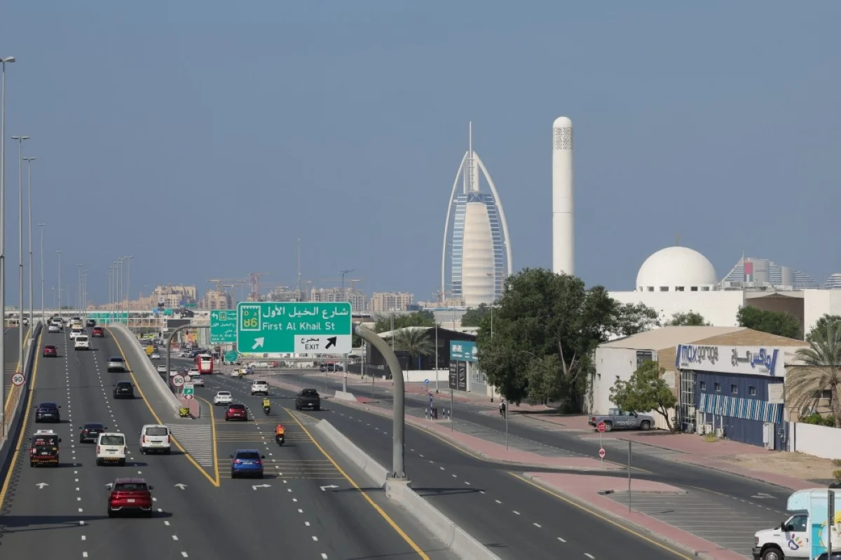 DUBAI: Traffic flows past Dubai's Gargash mosque (right) and its landmark Burj Al-Arab (center) luxury hotel on December 10, 2023. – AFP