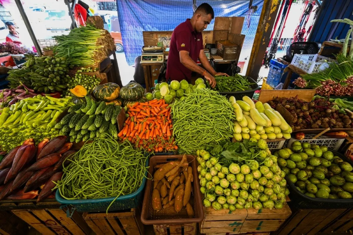 COLOMBO: A vendor sells vegetables at a market in Colombo on December 13, 2023. The International Monetary Fund revived its $2.9 billion bailout for Sri Lanka on December 12 after the South Asian nation clinched a debt restructuring deal with China, its biggest official lender. -- AFP