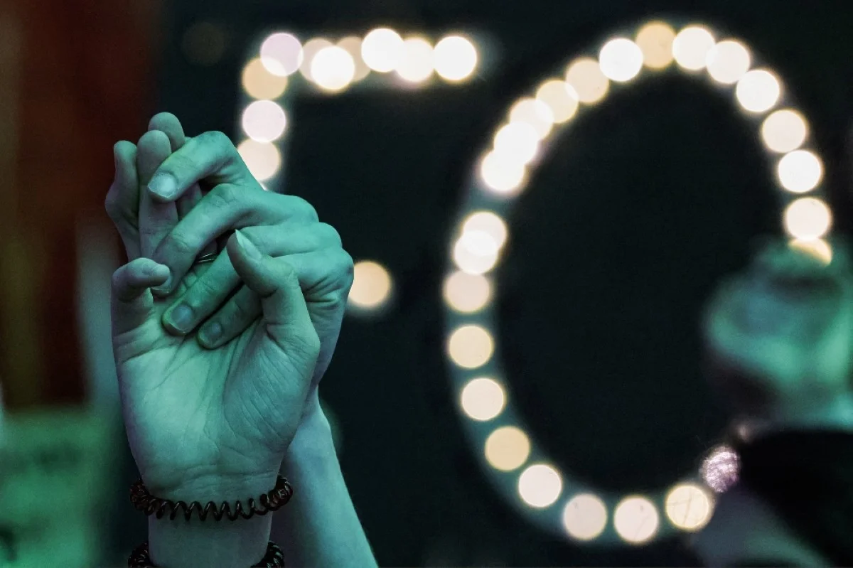 Climate activists hold hands together during a protest against fossil fuels during the United Nations Climate Change Conference COP28 in Dubai on December 12, 2023. --AFP