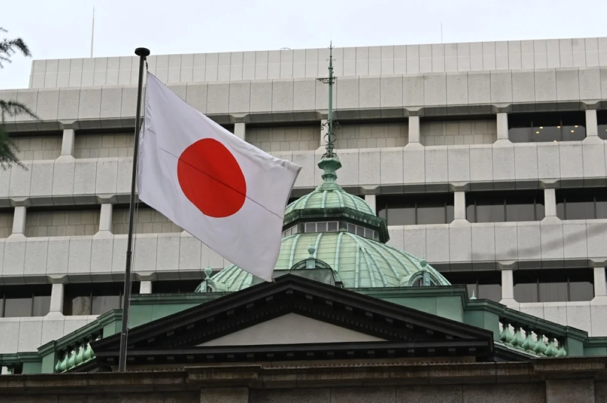 TOKYO, Japan: Japanese national flag flutters at the Bank of Japan headquarters in Tokyo on December 19, 2023. -- AFP