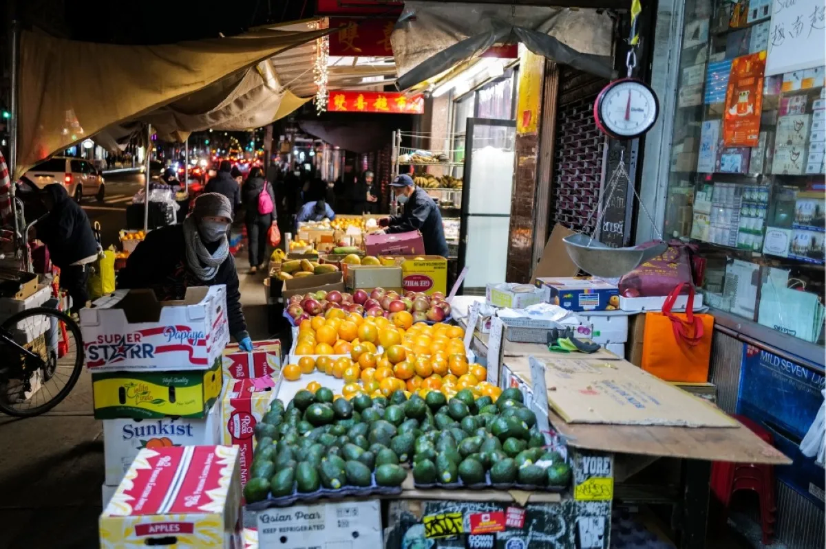 NEW YORK: An elderly Chinese woman sells fruits and vegetables in Chinatown in New York. – AFP